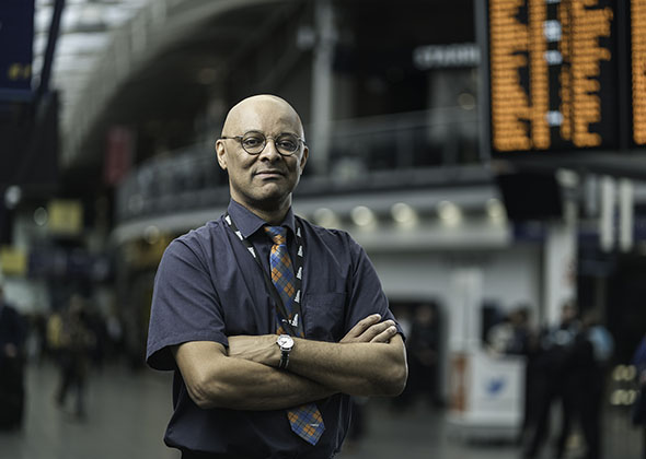 customer service assistant stood in a train station